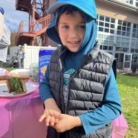 smiling kid with edible sukkah